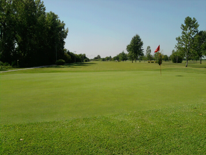 A hole with a red flag on a golf course in Columbia, IL